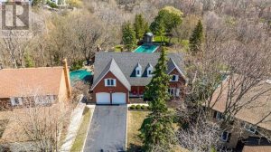 View of Hazel McCallion's Mississauga home with in-ground pool and garden